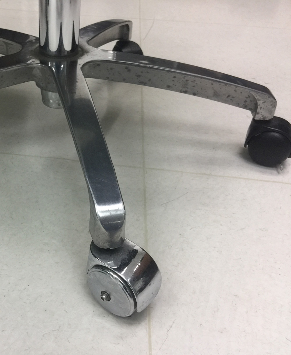 the legs and wheels of a rolling chair