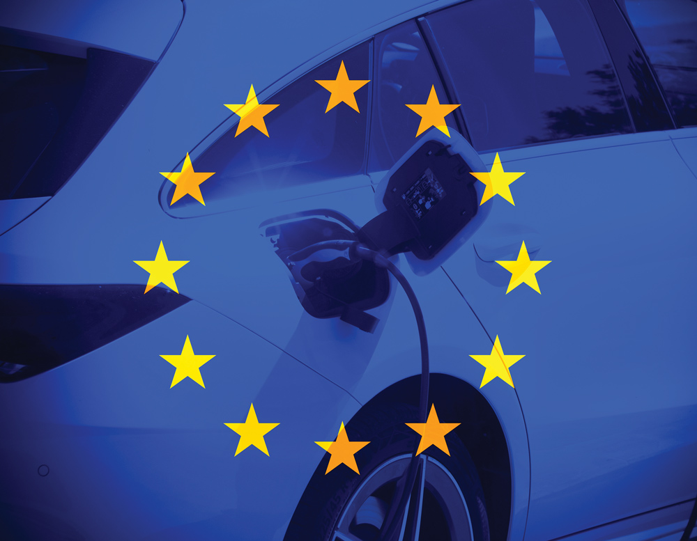 transparent flag of Europe with a close up on electrical car charging behind it