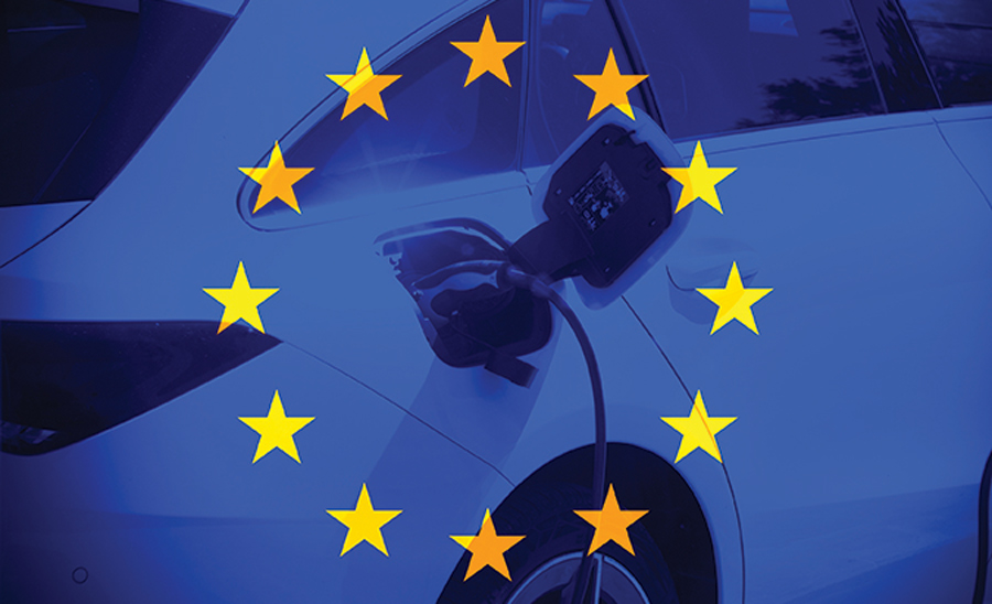 transparent flag of Europe with a close up on electrical car charging behind it