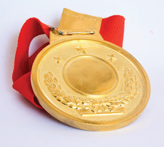 Golden medal on top of red ribbon