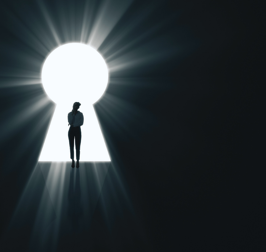 silhouette of woman in light coming through a keyhole