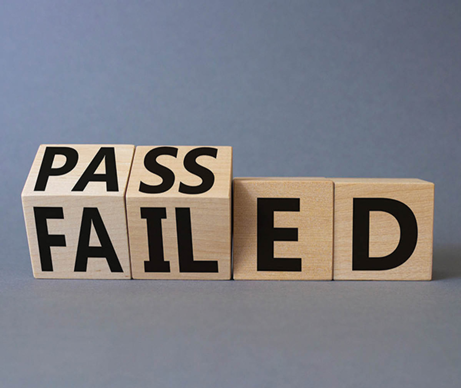 wooden blocked being turned to say "Passed" instead of "Failed"