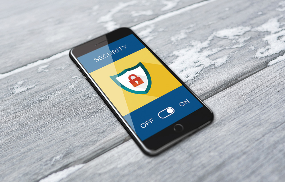 Close-up perspective of a smartphone with a security screen display message showing a secured cybersecurity vector digital logo on it and the on/off toggle button area below
