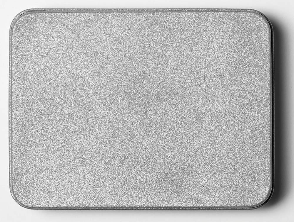 Top close-up photograph perspective of a grey colored/chrome rectangular metal plate enclosure box