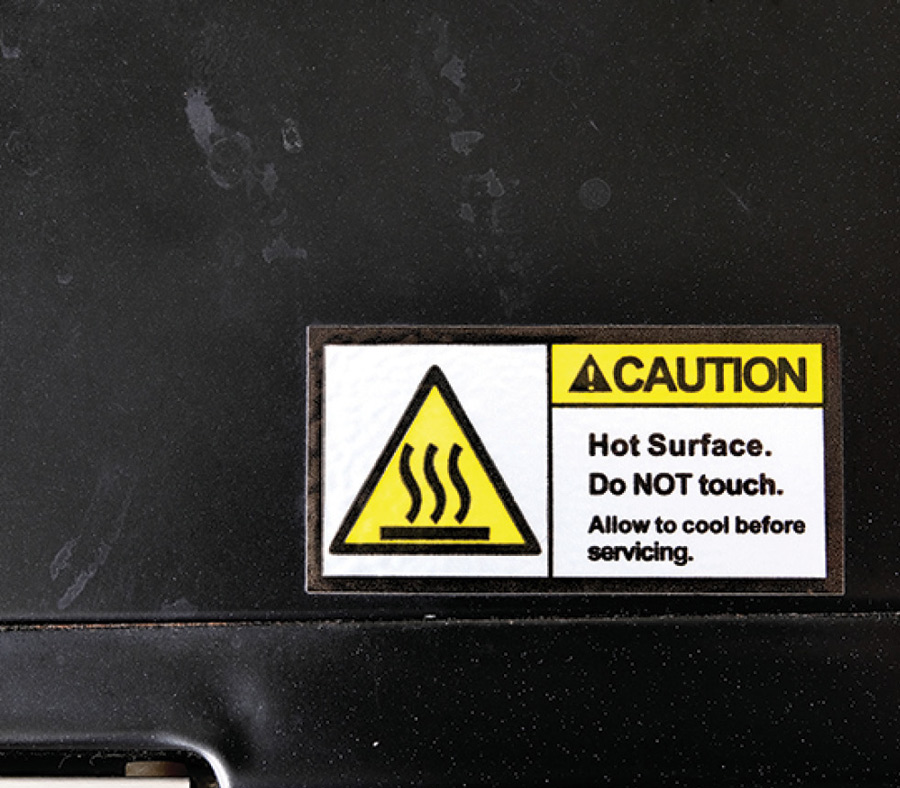 sticker reading CAUTION Hot Surface, Do NOT Touch