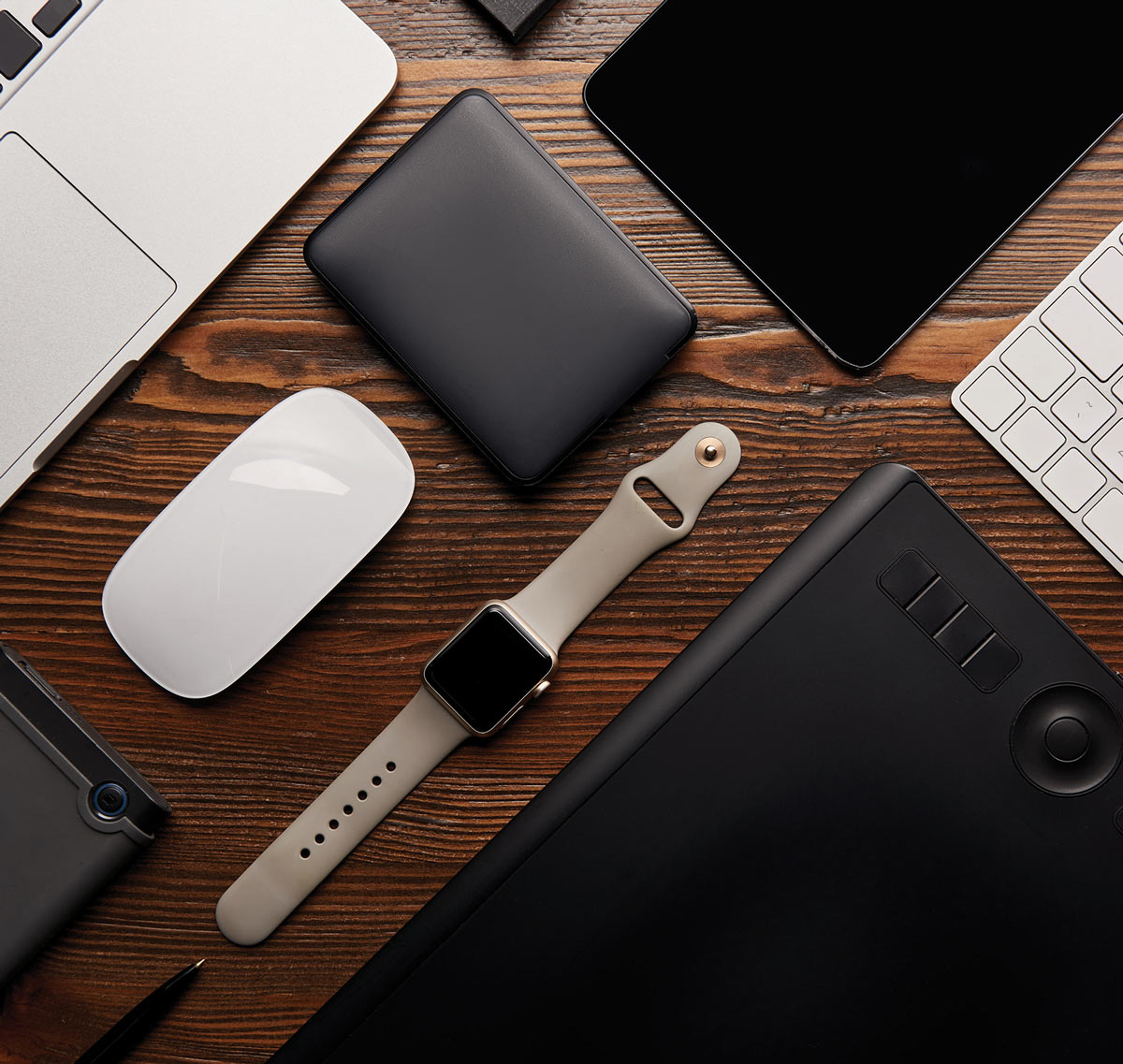 Various electronics laid out on wooden tabletop