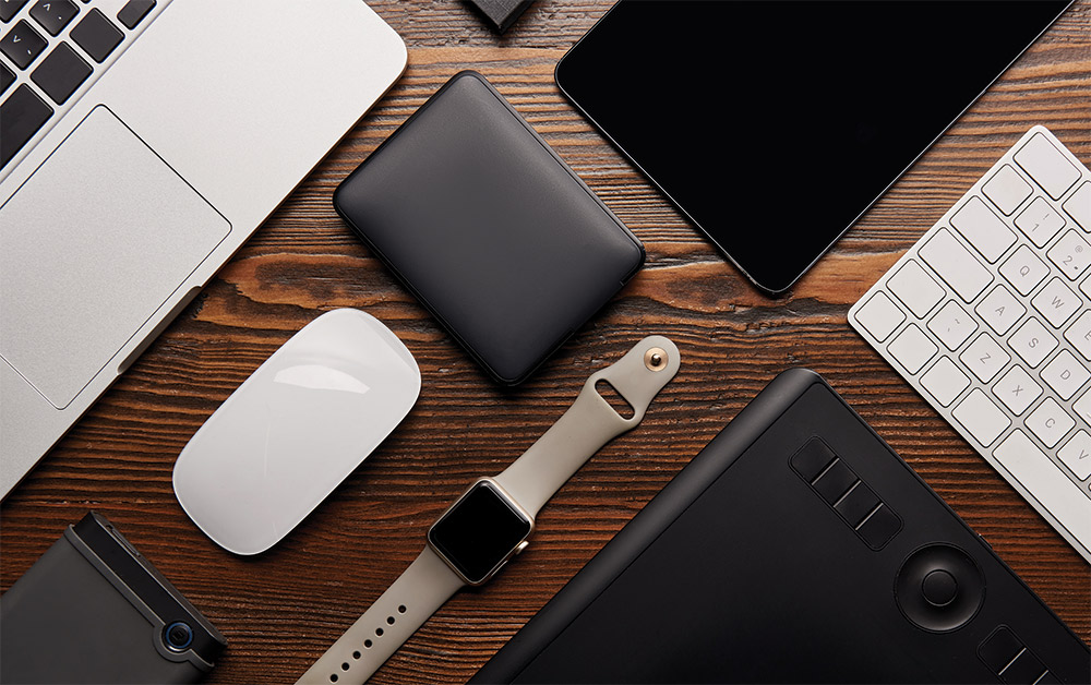 Various electronics laid out on wooden tabletop