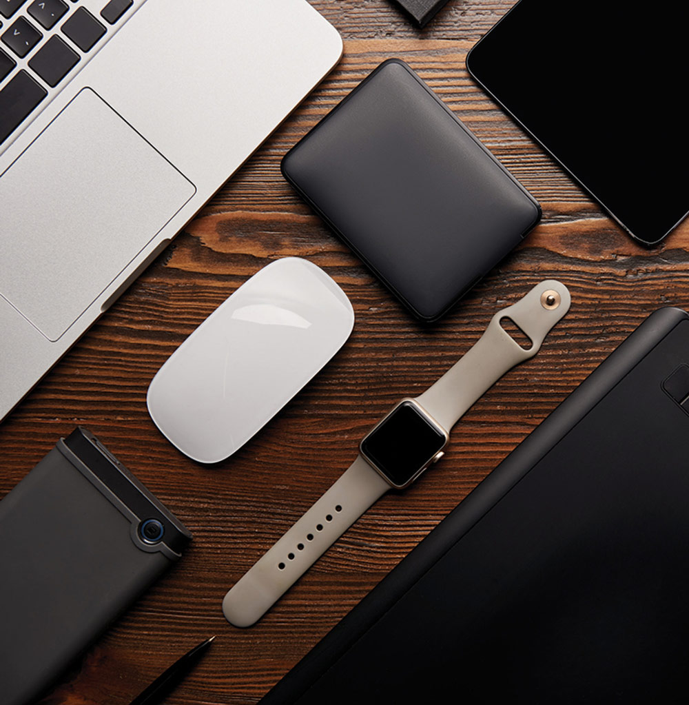 laptop, mouse, wallet, phone, Apple watch on a table