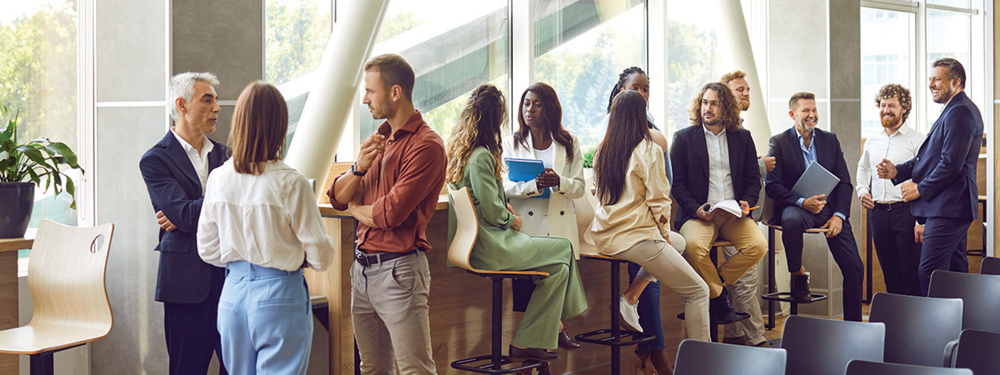 multiple sets of tables filled with people having conversations