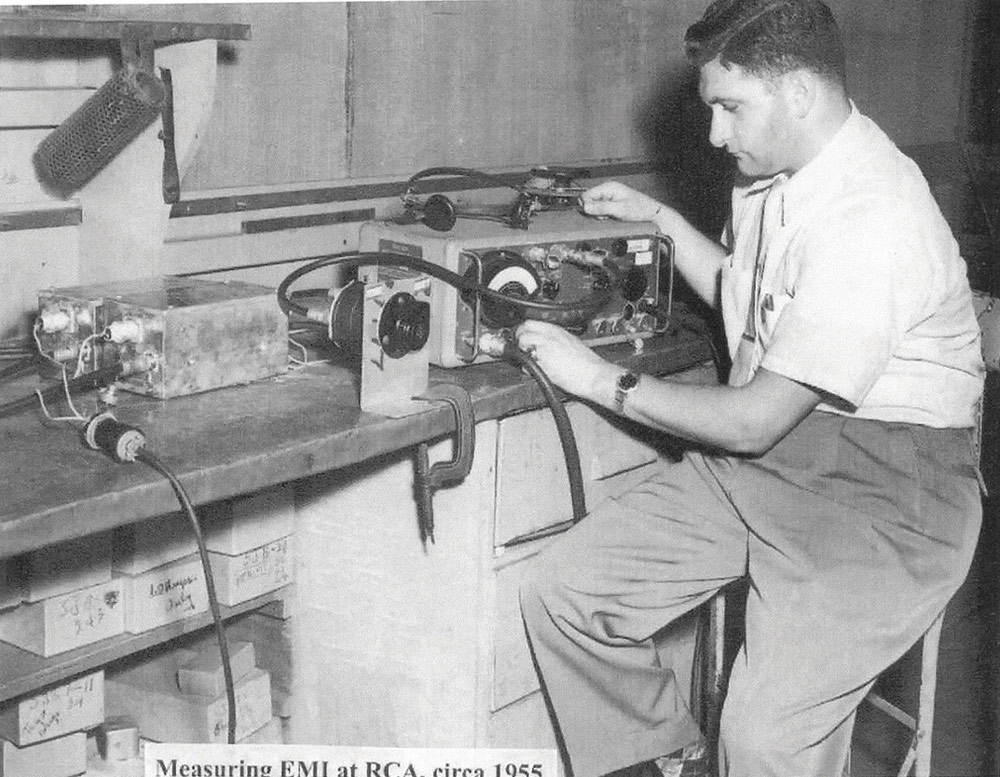 black and white photo of Vince Mancino at work at his electronic bench using a Stoddart RFI Receiver