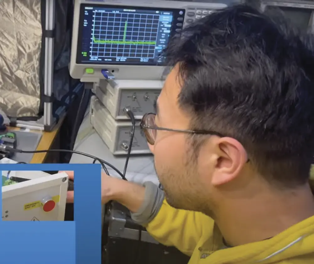 Dr. Min Zhang pictured as he uses a walkie-talkie to inject interference to the DUT