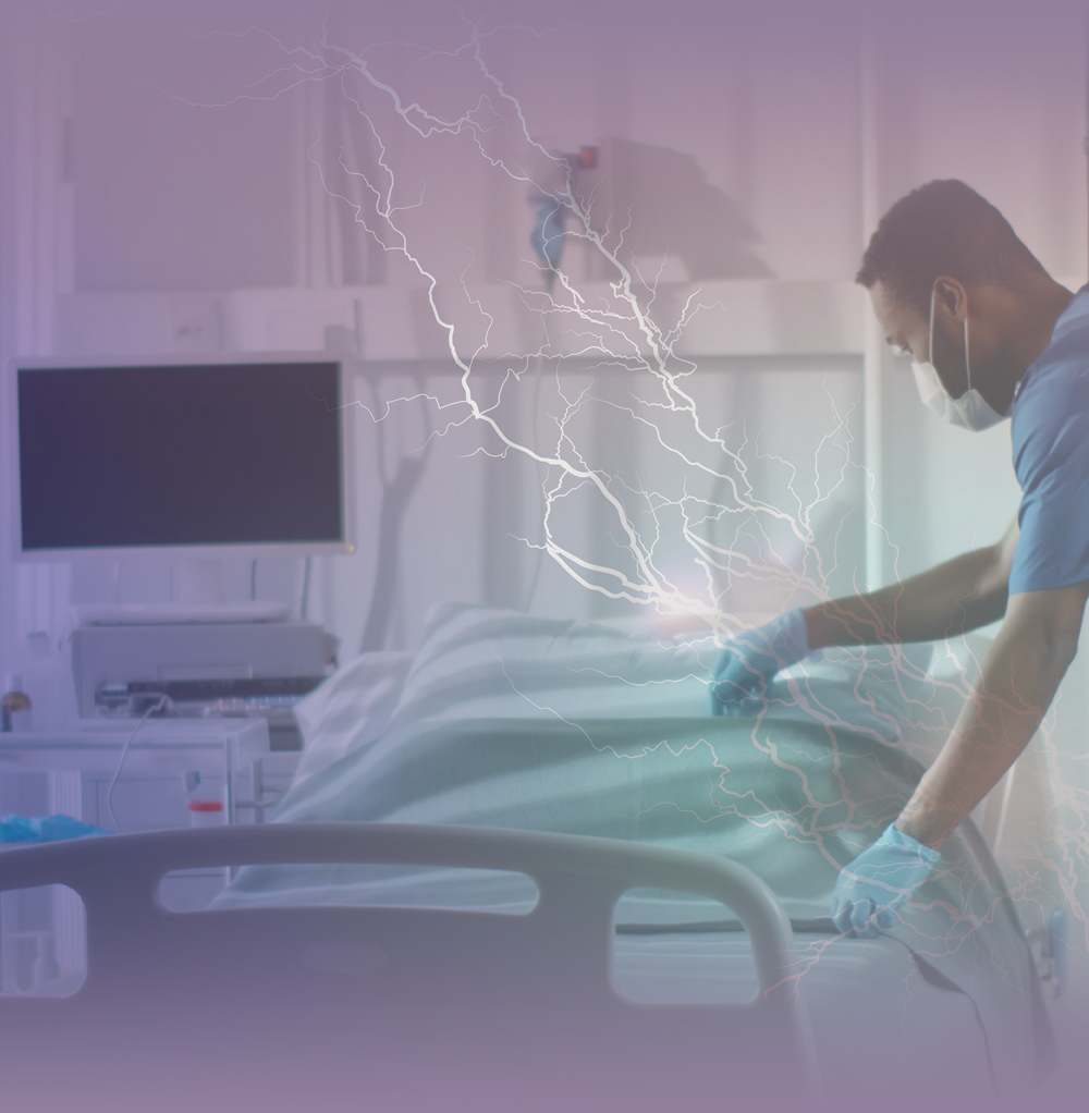 male nurse prepping a bed for an unseen patient