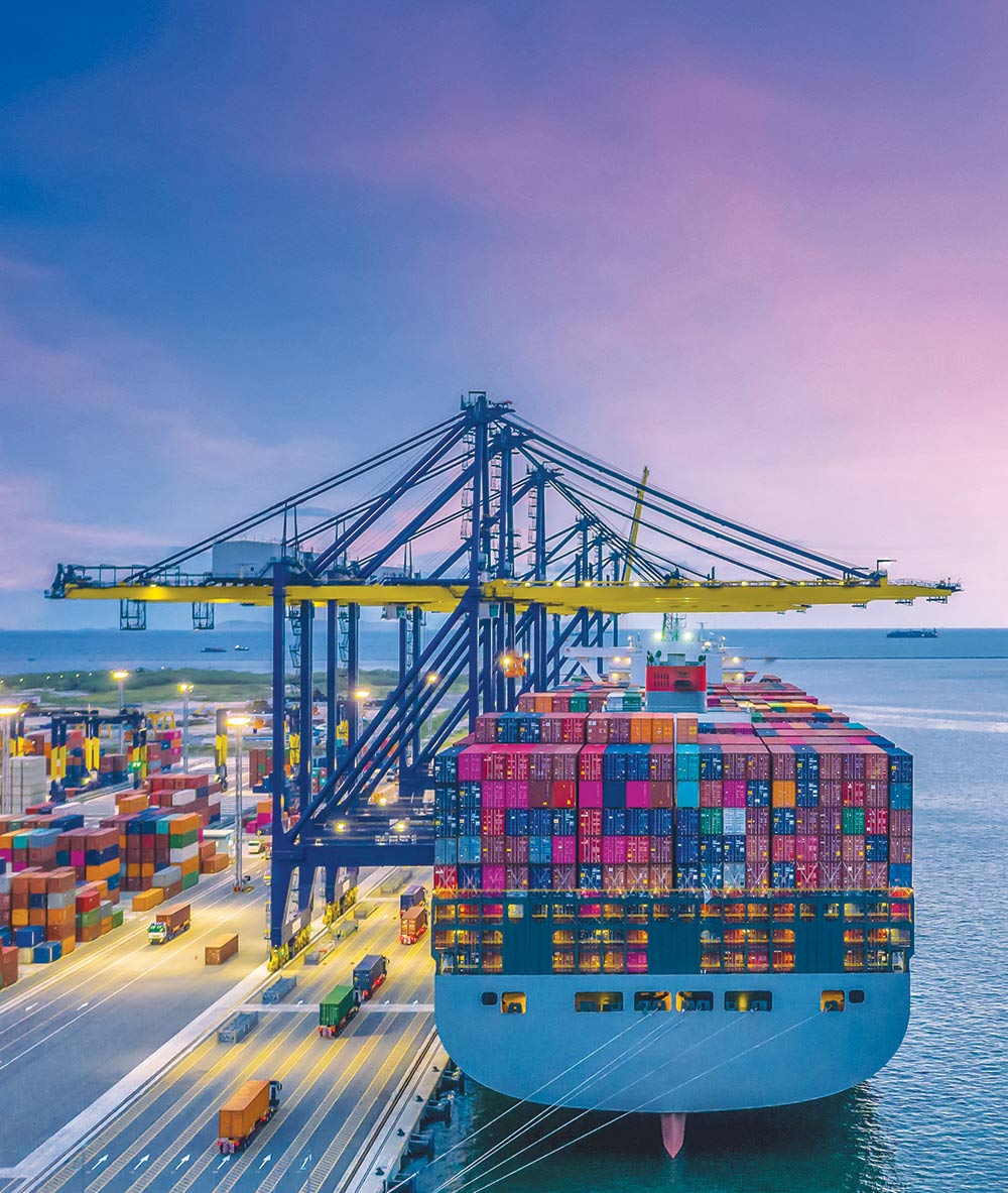 dock with cargo being loaded onto a cargo ship