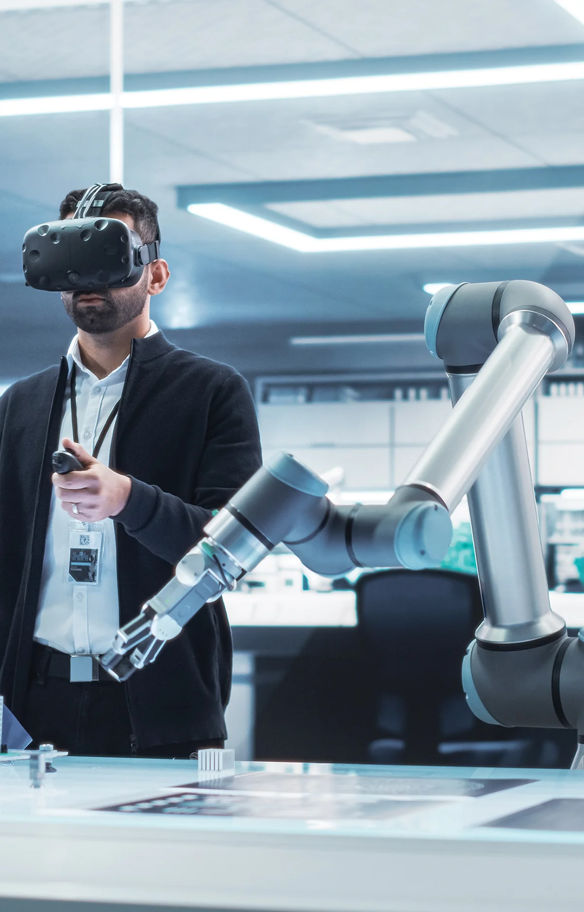 man wearing business casual clothing with a VR headset on his head and a robot on the ride