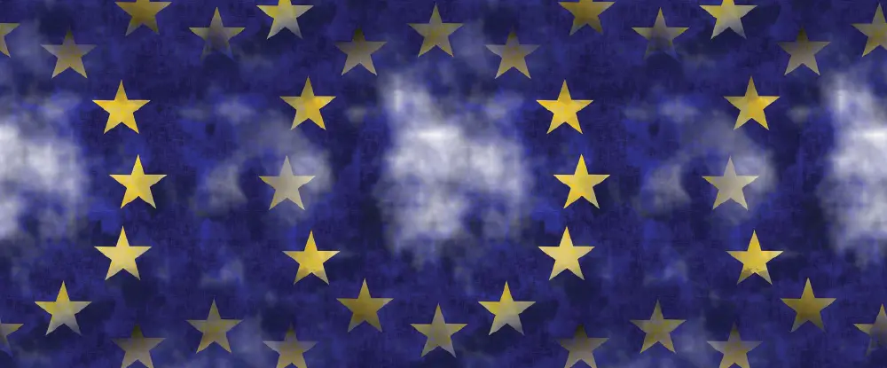 A repeating pattern featuring circles of five-pointed yellow stars against a dark blue background with wispy white cloud-like textures