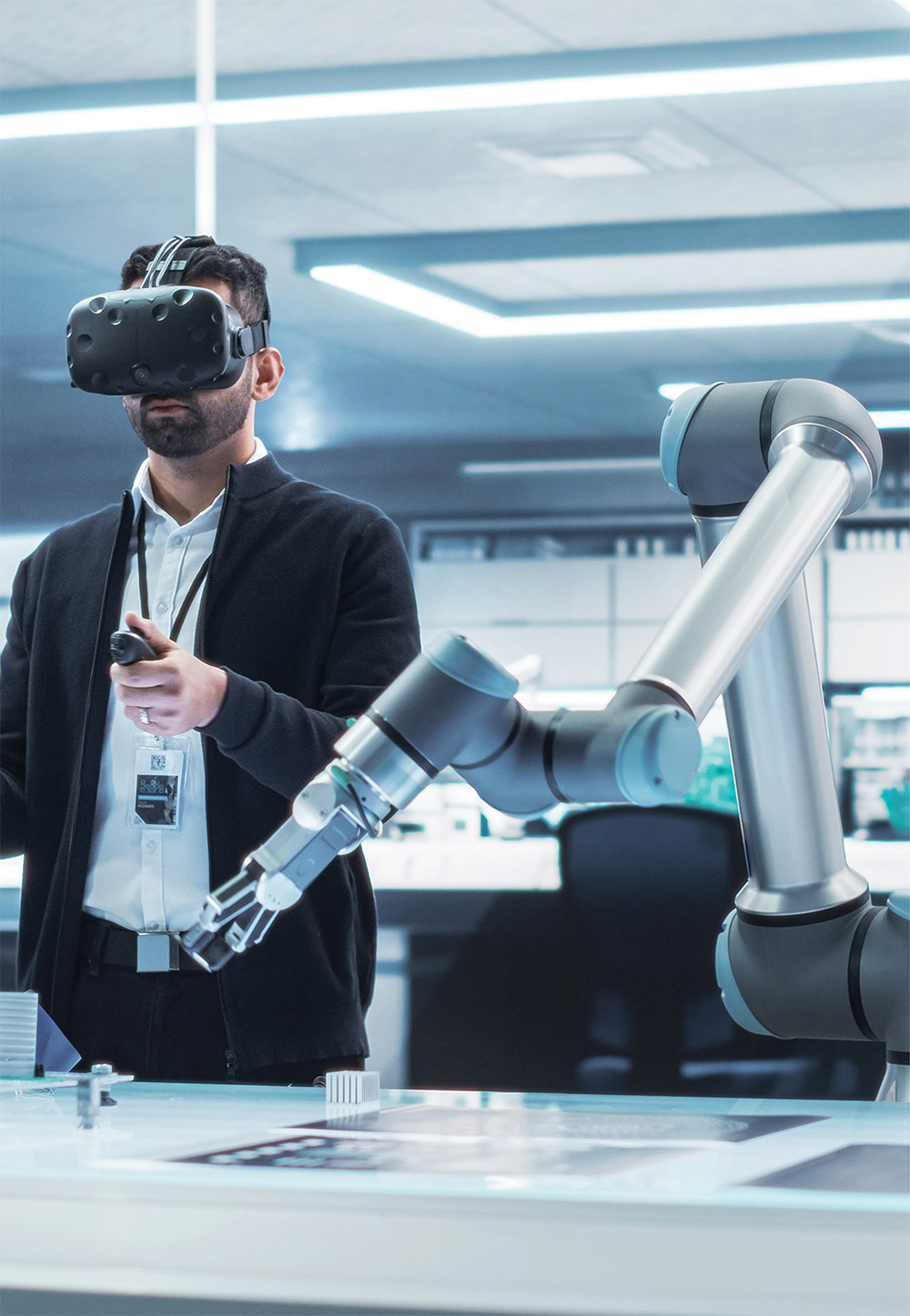 man with VR set controlling robotic arm