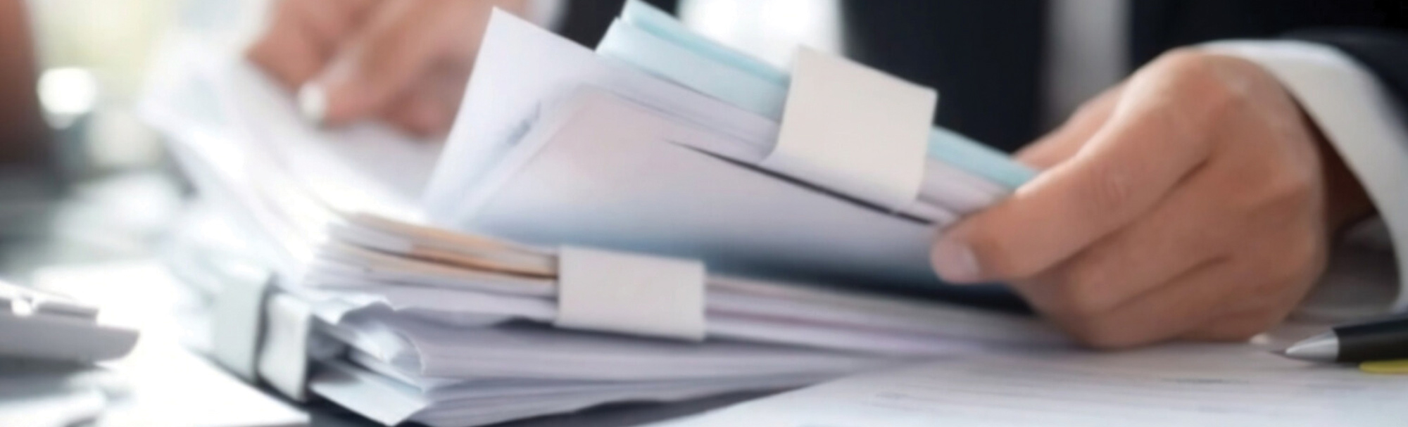Closeup of hands holding paperwork.