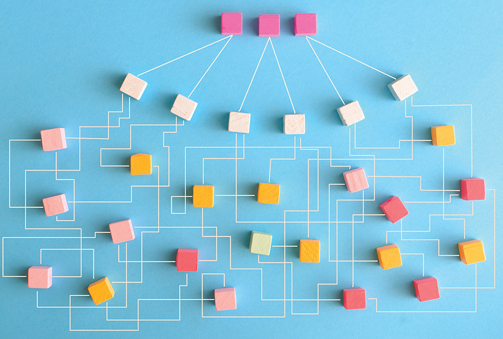 A complex network diagram of colorful wooden blocks connected by white lines on blue.