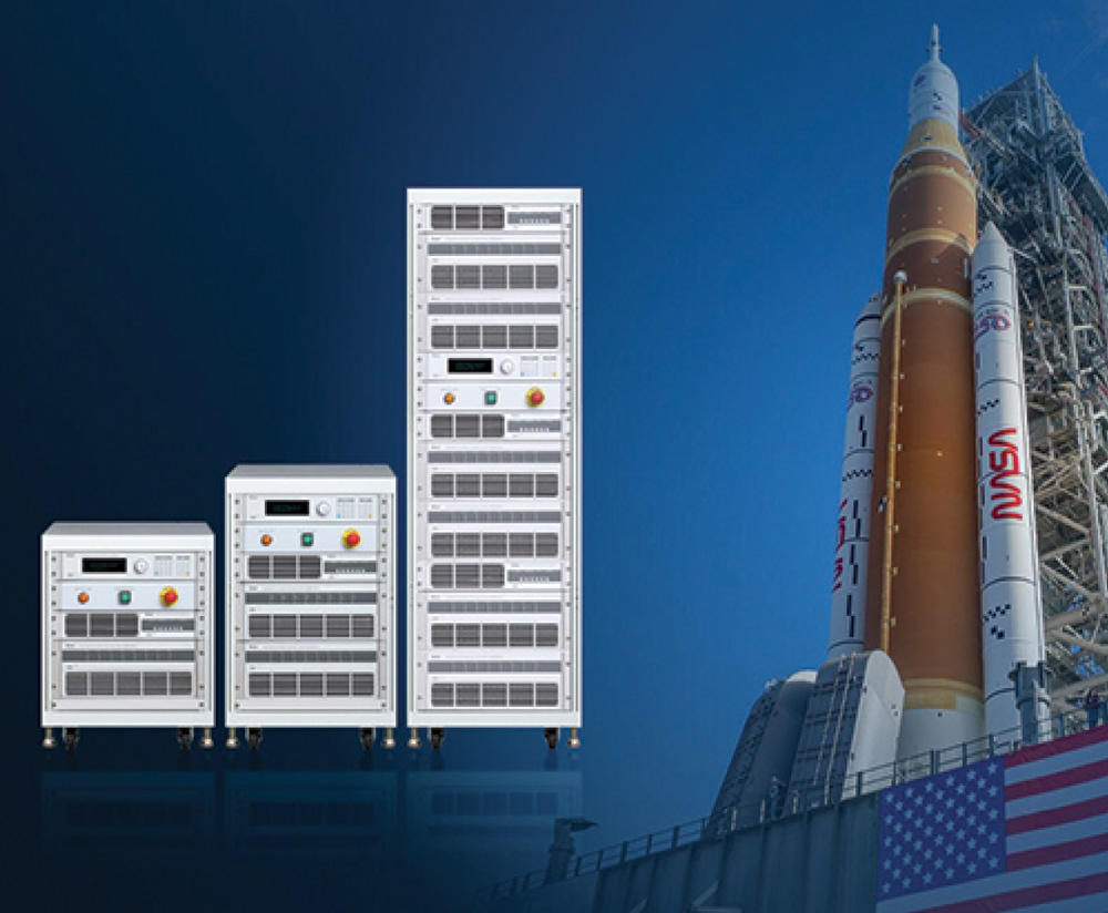 Three server equipment racks standing next to a NASA rocket on a launchpad.