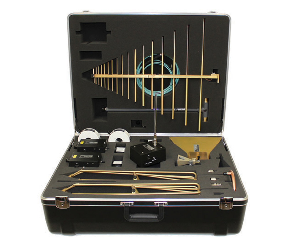 Open hardshell case containing various test antennas and RF measurement equipment organized in foam.