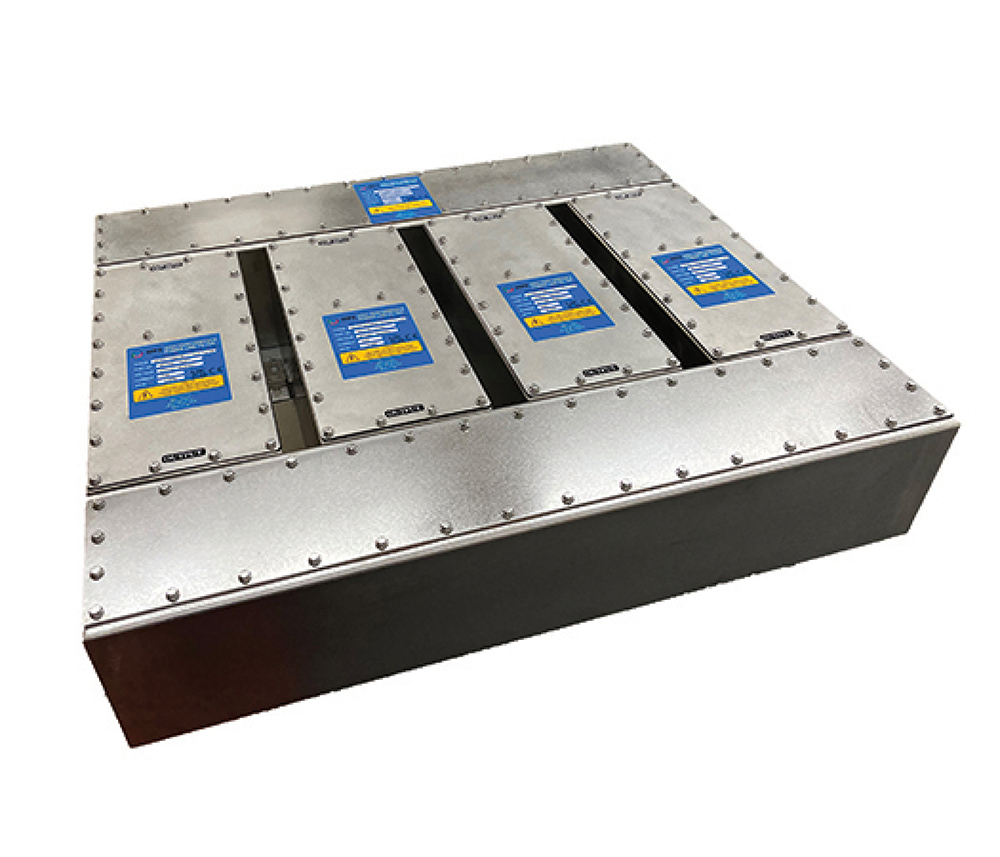 Large metal power line filter assembly housing with blue warning labels on top.
